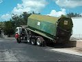 Roll-off Peterbilt320 Truck collects loaded Compactor Dumpster on 9-10-09