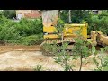Dozer clears away dirt and tree from the concrete street by Komatsu D31P Bulldozer wonderfully