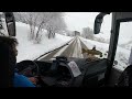 Bus driving downhill a snowy mountain, French Alps