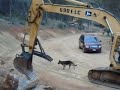 Excavator battles boulders for wall building