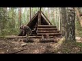 A MAN BUILDS A LARGE LOG CABIN ALONE. HOUSE IN THE WILD FOREST.