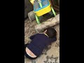 Toddler uses pillow as a pretend carwash