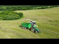 Slope grass silage for sheep with a Claas Jaguar 980 mower and John Deere and Case IH tractors