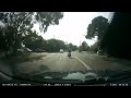 Red light runner around motorbike