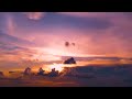 Clouds Pass By While Sun Sets Against a Heavenly Purple Sky Timelapse Stock Footage [4K]