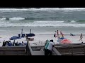 Surfers attempt to ride wave's