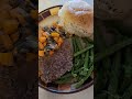 Cube steak, a roll, and veggies