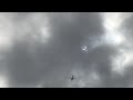 plane crosses over crescent sun