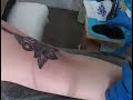 Sewing scissors blooming out of a flower tattoo