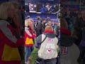 Taylor Swift walks on the field to congratulate Travis Kelce after the Chiefs AFC Championship win