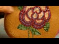 Teri Greeves demonstrates beading techniques for moccasins