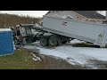 Loading and unloading roll off dumpster