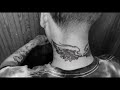 wings on neck tattoo.