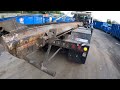 Garbage truck unloading a roll off container