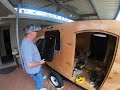 Cut a hole in your Vintage wood camper for the install of a modern camper window with a screen for