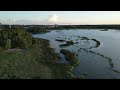 Arial view of Bonfire in middle of Jungle near a Lake