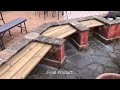 Installation of wooden benches against small wall in garden