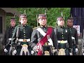 Black Watch Pipes and Drums lead the Royal Guard out of Balmoral Castle with pony mascot Cruachan IV