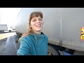 Young female truck driver changing a flat tire