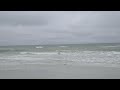 Waves crashing on the beach on an overcast day