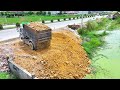 Nice Showing Action Filling Up The Land, By Transaction Bulldozer KOMATSU D31P, Dump truck Unloading