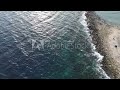 aerial view of pebble beach with blue sea