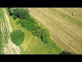 Harvesting hay on a slope with John Deere and Case IH tractors with Pöttinger, Krone & Lely
