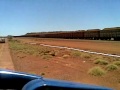 Loaded Marandoo Ore train cruises past towards loop and crossing with empty ore train