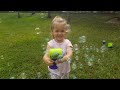 KIDS MAKE 1000 SOAP BUBBLES. ENTERTAINMENT VIDEO FOR CHILDREN. KIDS PLAY ON GREEN GRAS UNDER SUN.