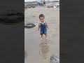 Happy baby inside the sea beach.